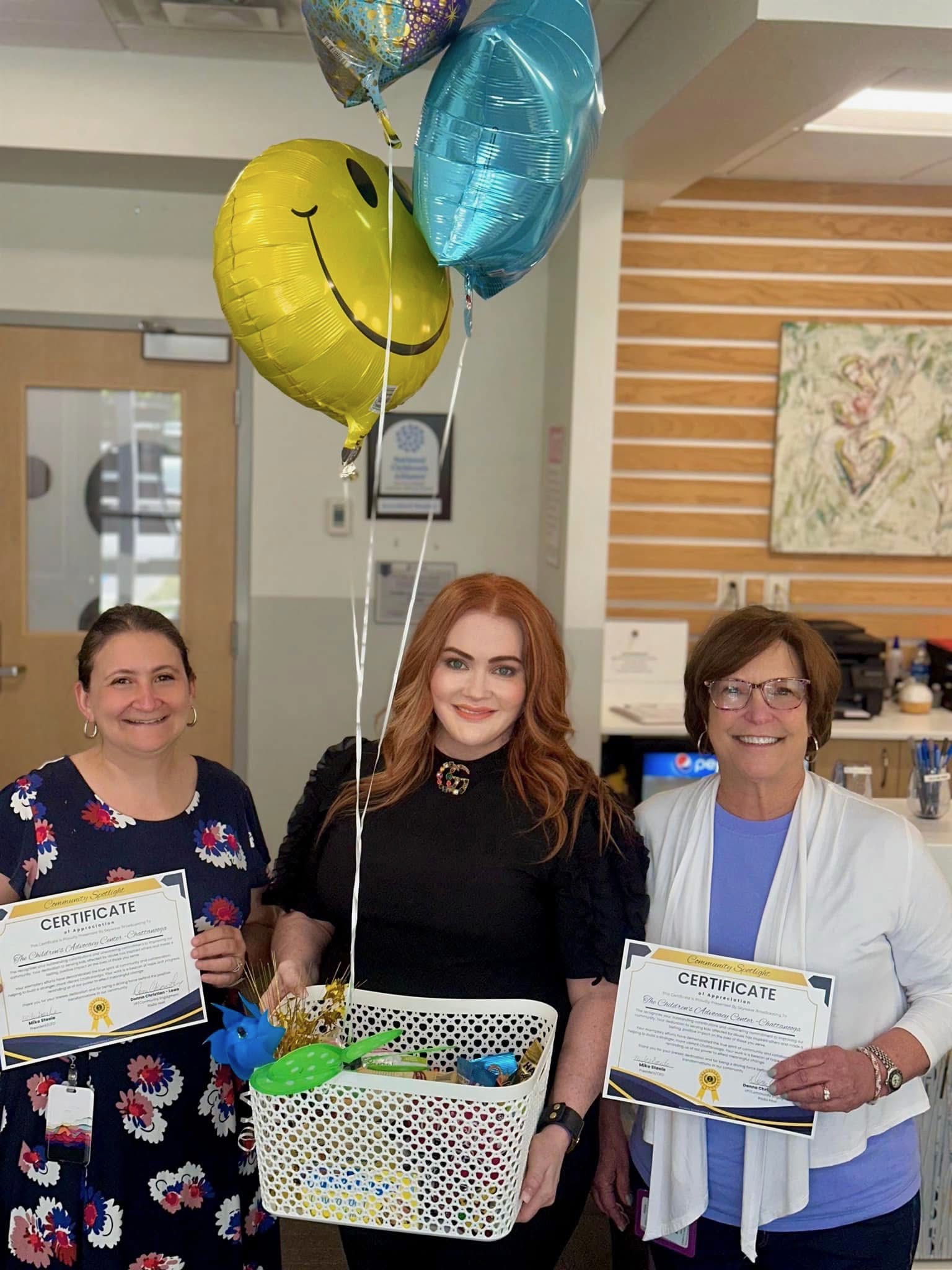 Donna Christian-Lowe presenting a Community Spotlight recognition to representatives of the Children’s Advocacy Center of Chattanooga.