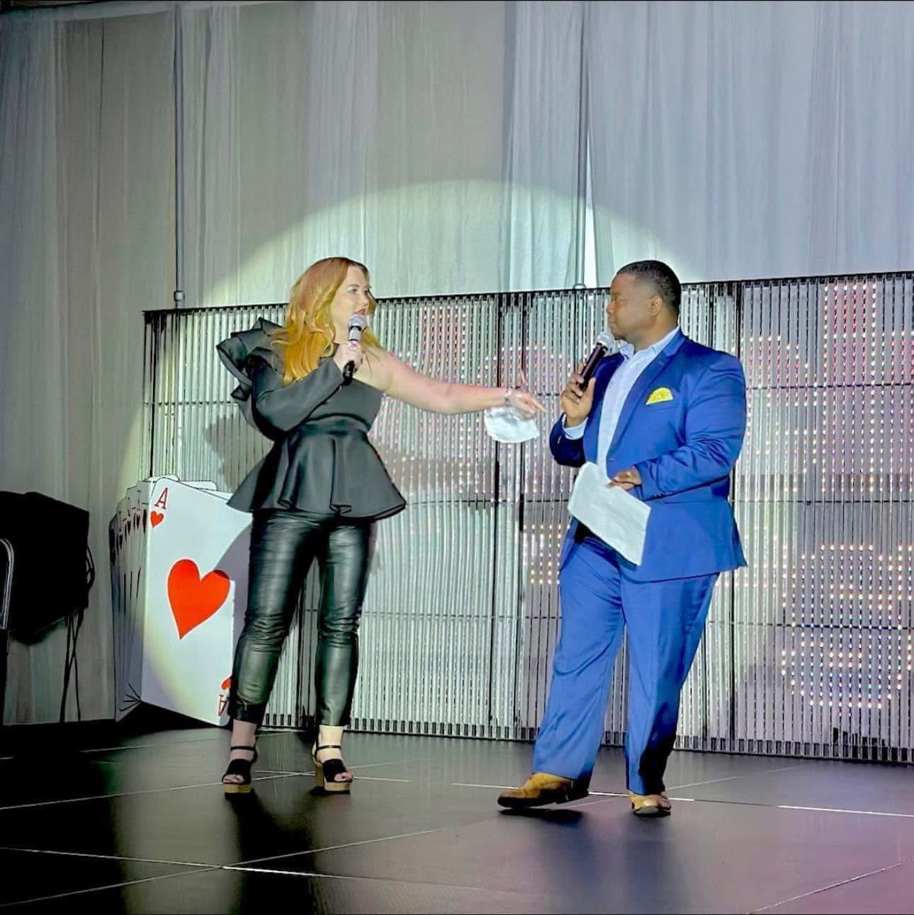Donna Christian-Lowe hosting an event on stage with a co-host