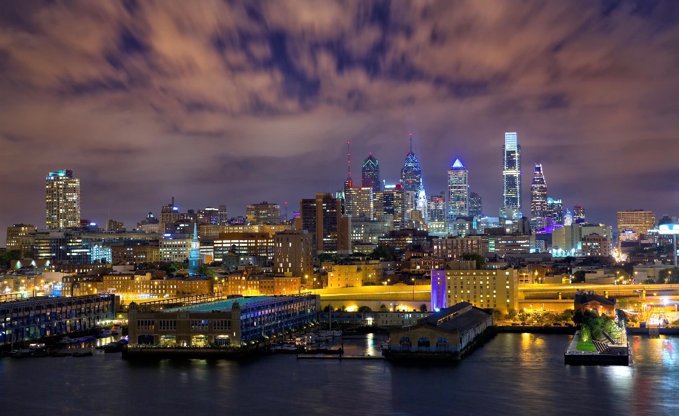 The illuminated Philadelphia skyline reflected across the river at night