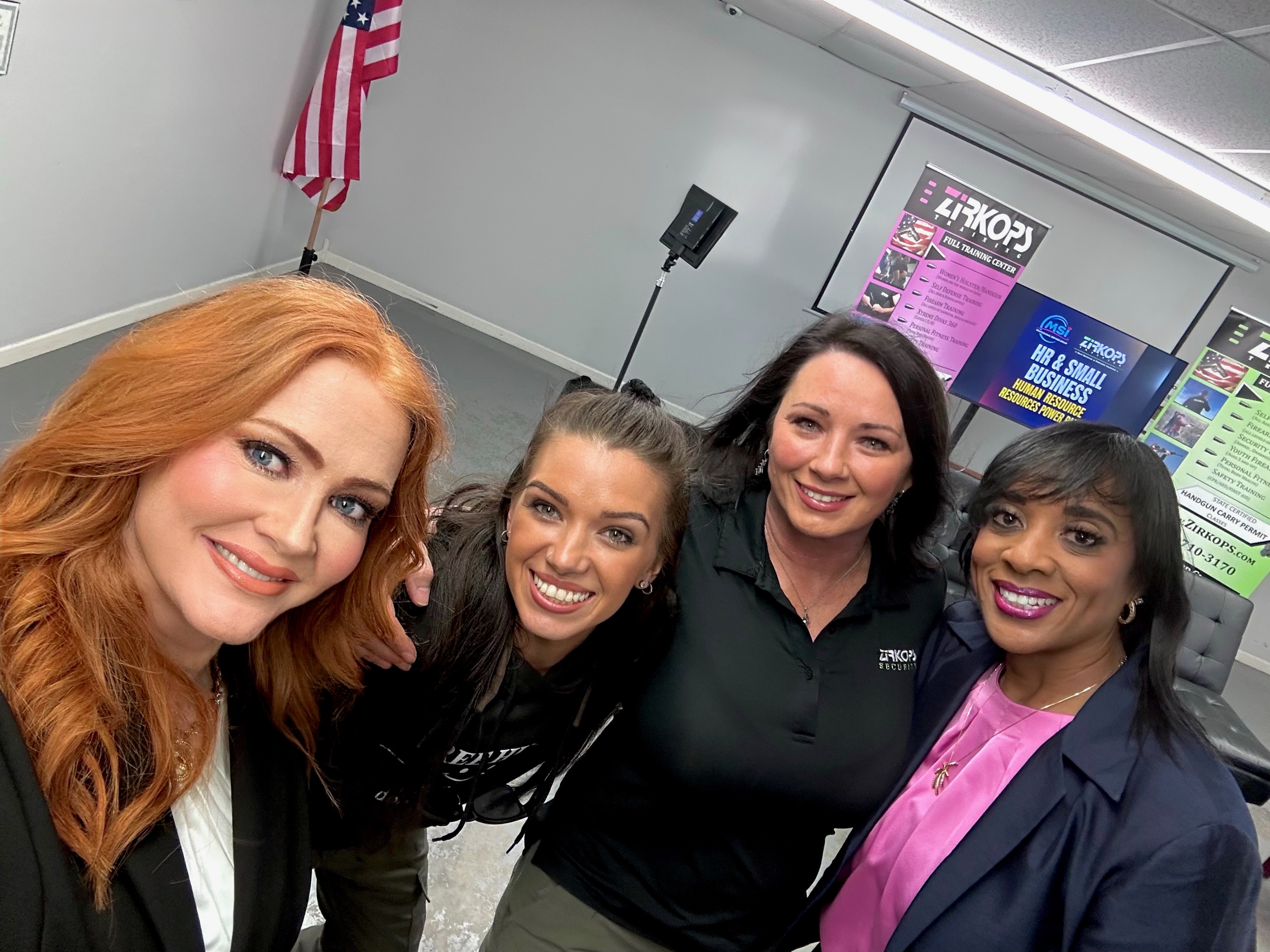Four HR Power Panel participants taking a group selfie at the event