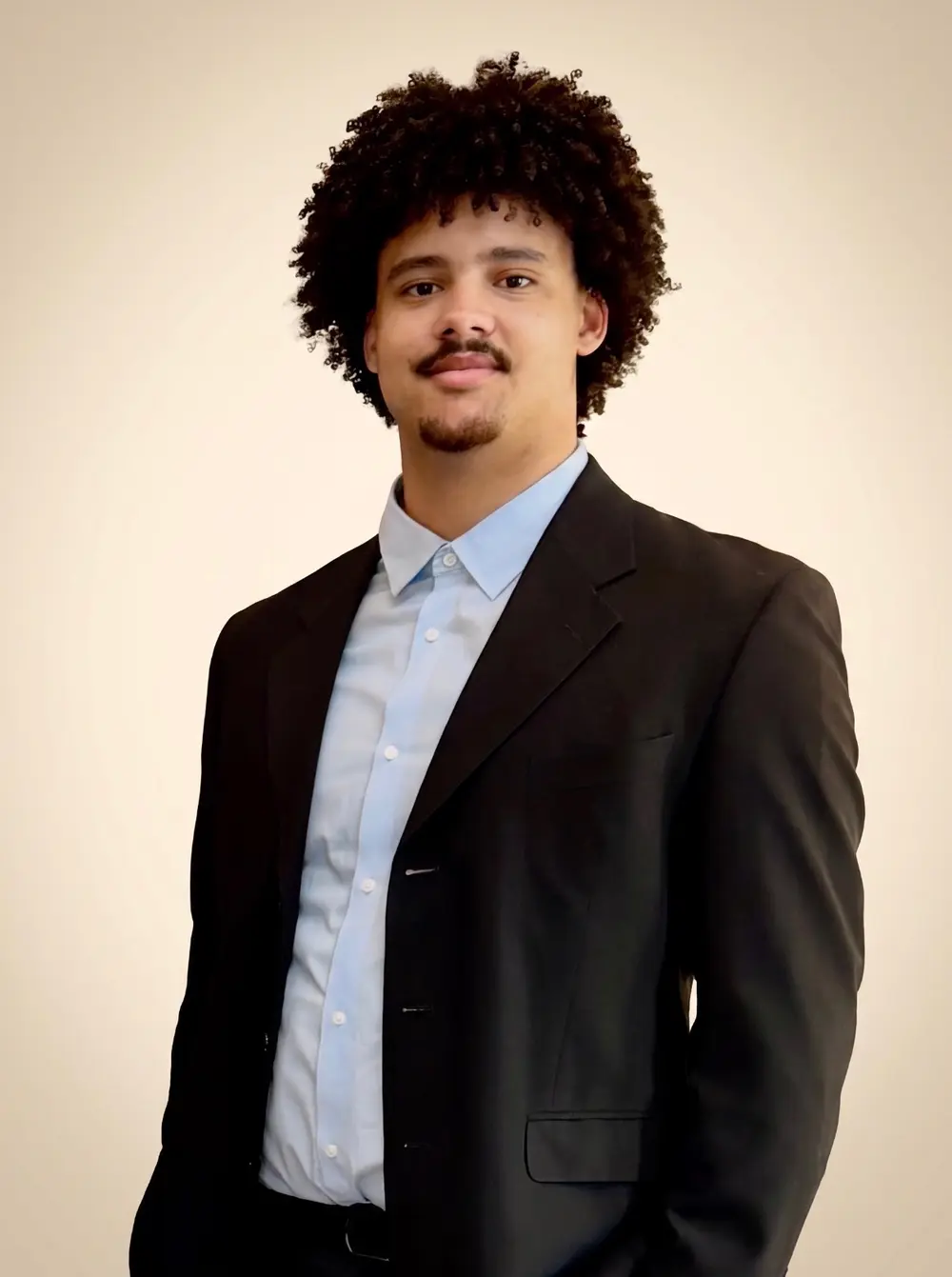 Mason wearing a burgundy suit and light powder blue shirt